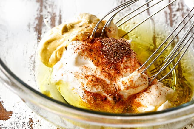 Showing how to make dressing with mayo for Shrimp Pasta salad by adding mayo, mustard, horseradish, lemon juice to glass bowl