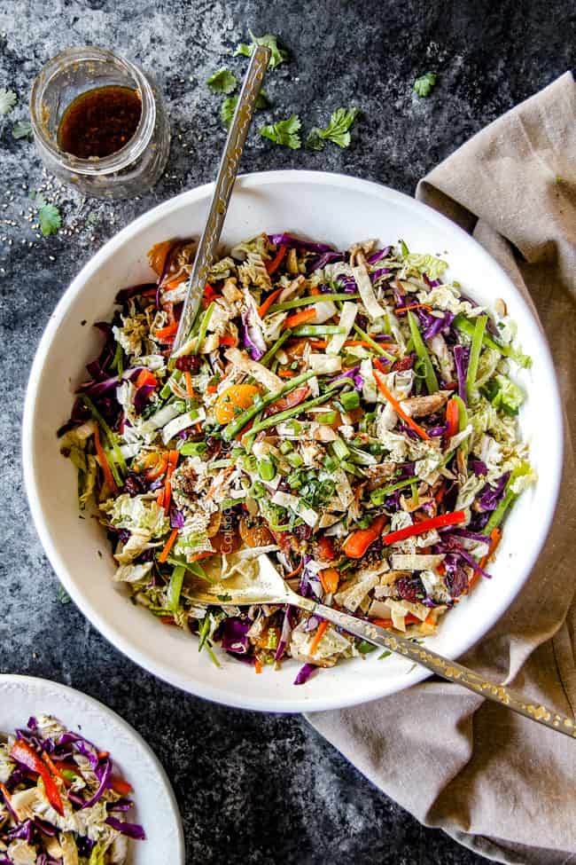 far away top view of best ever Chinese chicken salad tossed together with mandarin oranges, peanuts napa cabbage, wontons, carrots, snow peas, red bell peppers and sesame dressing