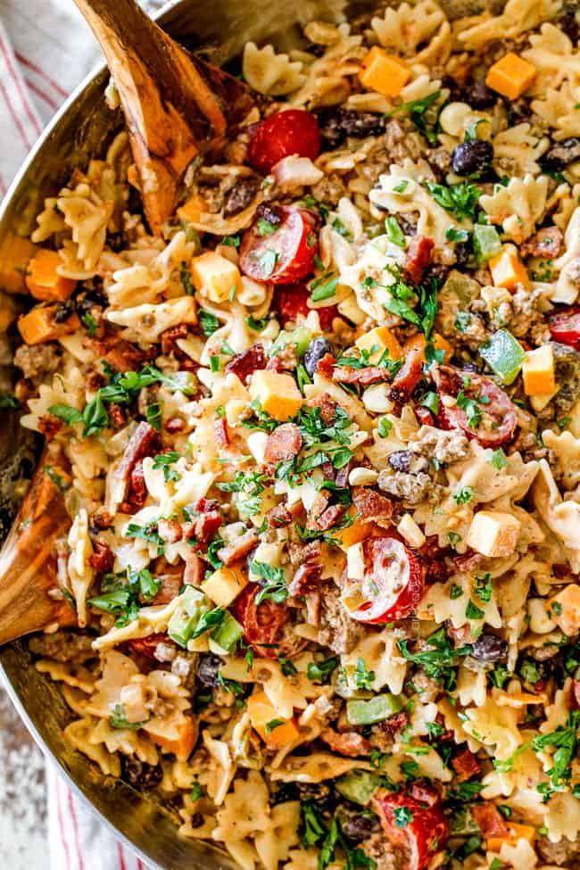 top view of easy Cowboy Pasta Salad with ground beef, black beans, corn, tomatoes and barbecue sauce in a metal bowl