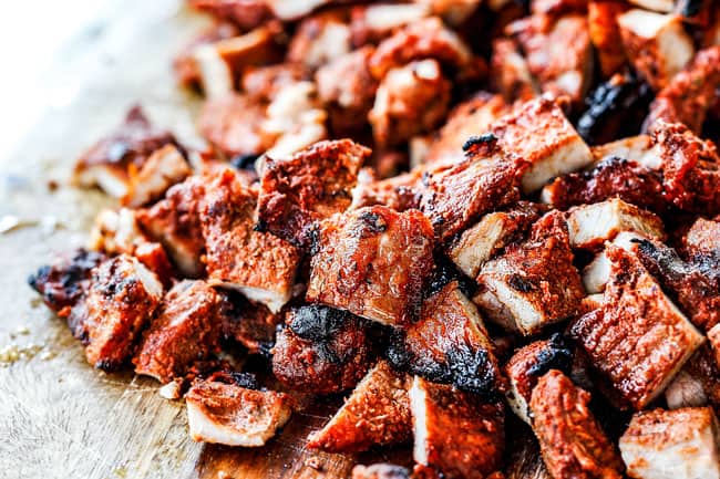 showing how to make al pastor with chopped al pastor on a cutting board