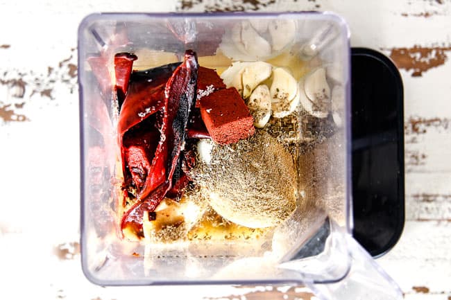 showing how to make al pastor marinade with guajillo chiles, ahciote paste, onions, garlic, pineapple juice in a blender