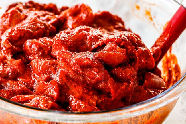 showing how to make al pastor with up close of bright red marinated al pastor pork thinly sliced