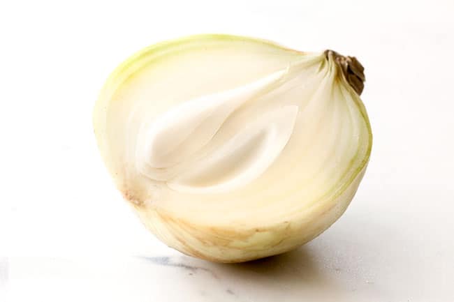 yellow onion sliced in half showing ingredients for easy pico de gallo