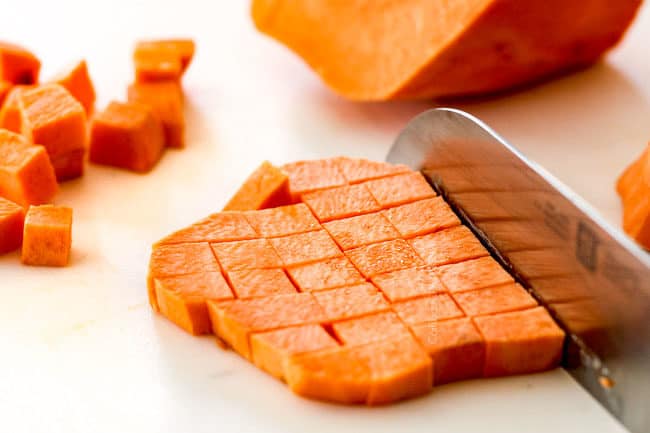 showing how to make sheet pan chicken and potatoes by shopping sweet potatoes