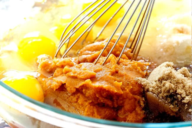 showing how to make best pumpkin bars by whisking the wet ingredients together in a glass bowl