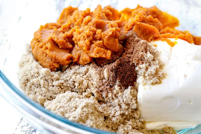showing how to make pumpkin dip with cream cheese, brown sugar, pumpkin, cinnamon in a glass bowl