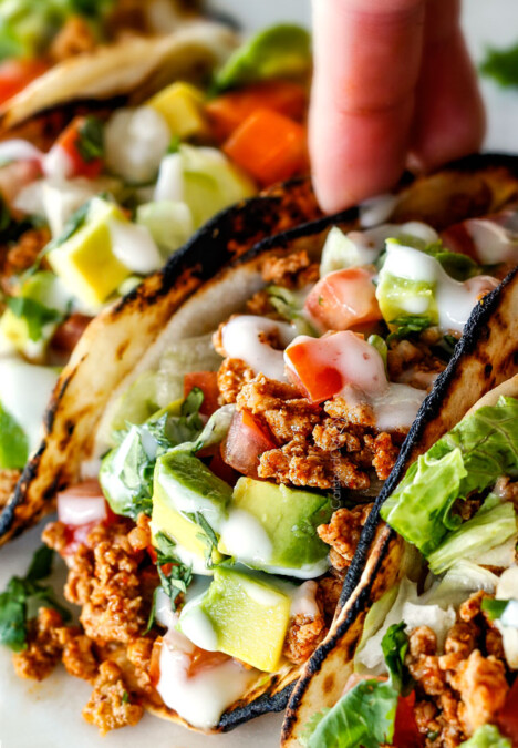 picking uo a healthy turkey taco with one hand