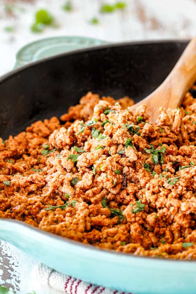 showing how to make ground turkey tacos by making ground turkey in a skillet with taco seasonings
