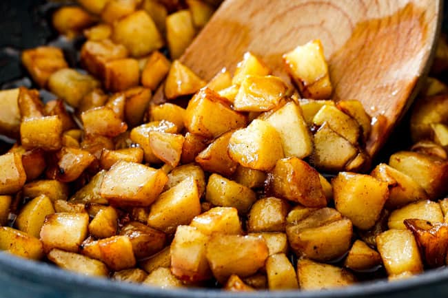 showing how to make salted caramel apple pie by cooking apples in butter and cinnamon