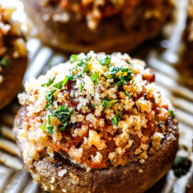 side view of best sausage stuffed mushrooms on a baking sheet with cream cheese filling and panko topping