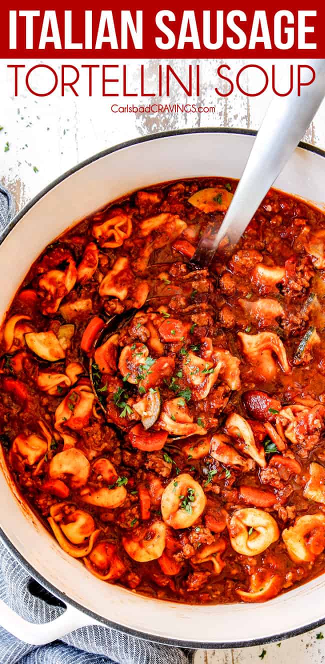 top view of a white Dutch oven of sausage tortellini soup