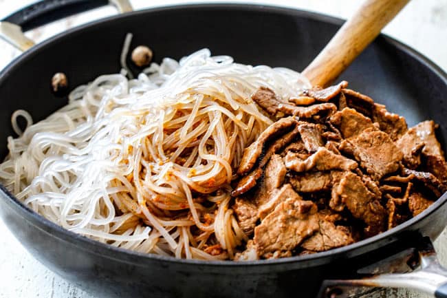 showing how to make Korean Spicy Noodles by adding cellophane noodles, spicy sauce and beef together in a skillet