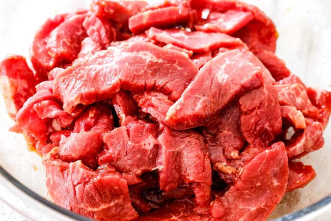 showing how to make Korean Spicy Noodles by marinating beef in soy sauce, brown sugar, garlic ginger, sesame oil, gochuchang