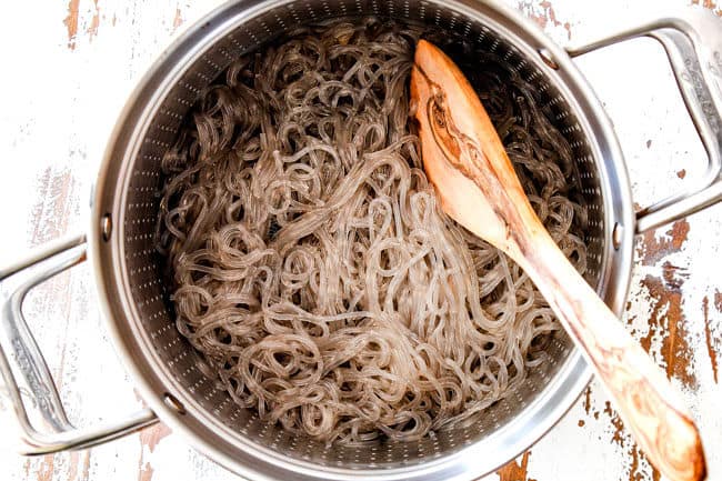 showing glass noodles in a strainer for Korean Spicy Noodles