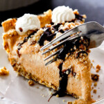 taking a bite of ice cream pie with vanilla ice cream, pure pumpkin and chocolate sauce
