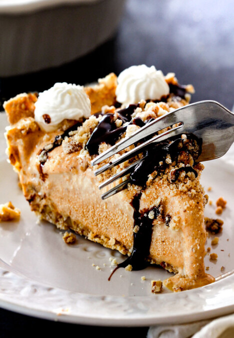 taking a bite of ice cream pie with vanilla ice cream, pure pumpkin and chocolate sauce
