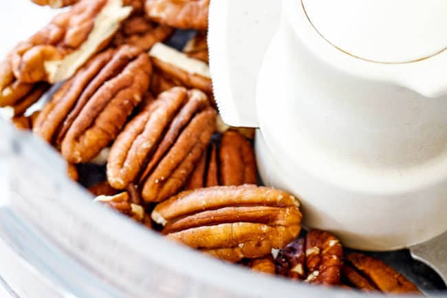 showing how to make easy pumpkin muffins by adding pecans to a food processor