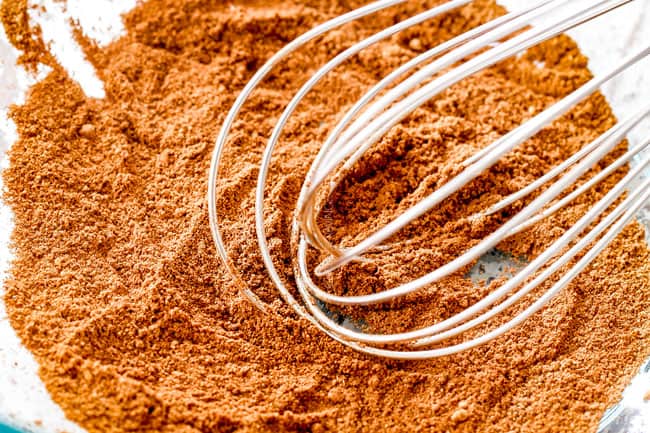 showing how to make poke cake by mixing cinnamon, nutmeg, ginger and cloves together