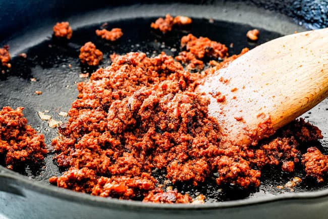 showing how to make queso fundido by cookinig chorizo in a skillet