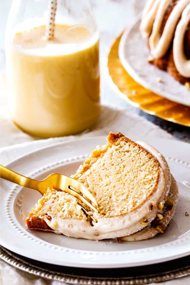 a slice of moist eggnog cake on its side with fork taking a bite