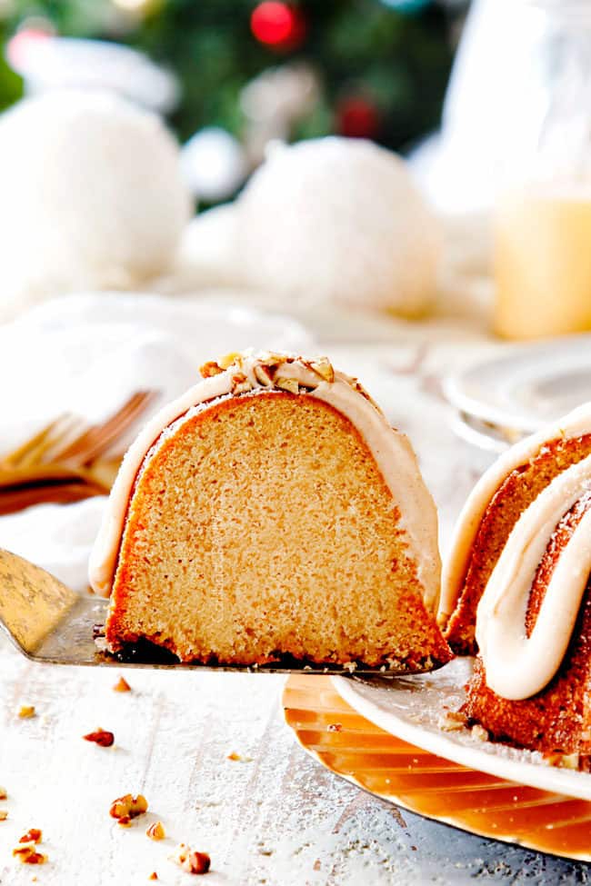 pulling a slice of holiday Eggnog Cake away from the cake