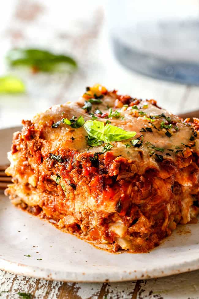 up close of a slice of the best lasagna with layers of ricotta, noodles, meat sauce, mozzarella, Parmesan