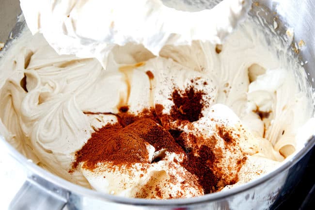 showing how to make best pecan pie cheesecake by adding cinnamon, cloves and nutmeg to cream cheese filling in mixere