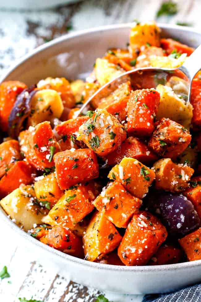 a servings spoon of roasted root vegetables with garlic and Parmesan