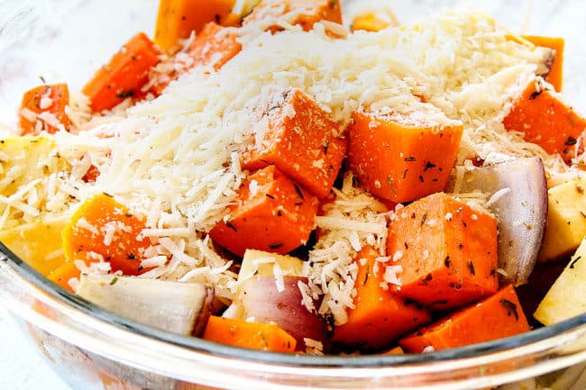 showing how to make oven roasted root vegetables by adding Parmesan to vegetables in a glass bowl