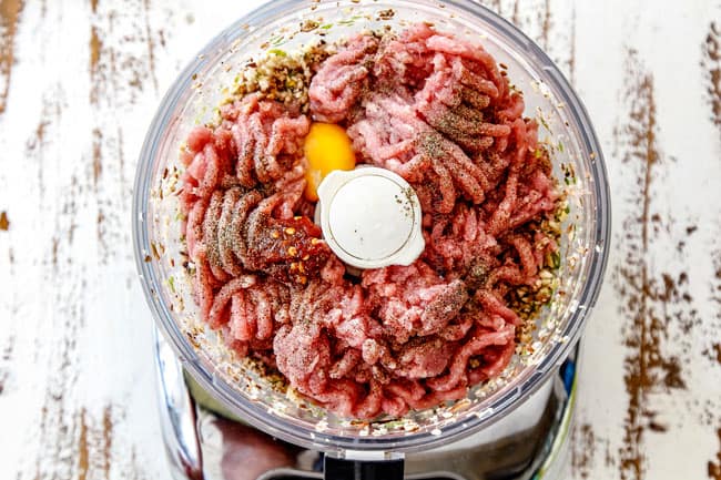 showing how to make wonton filling for Wonton Soup by adding ground pork, soy sauce, egg to food processor