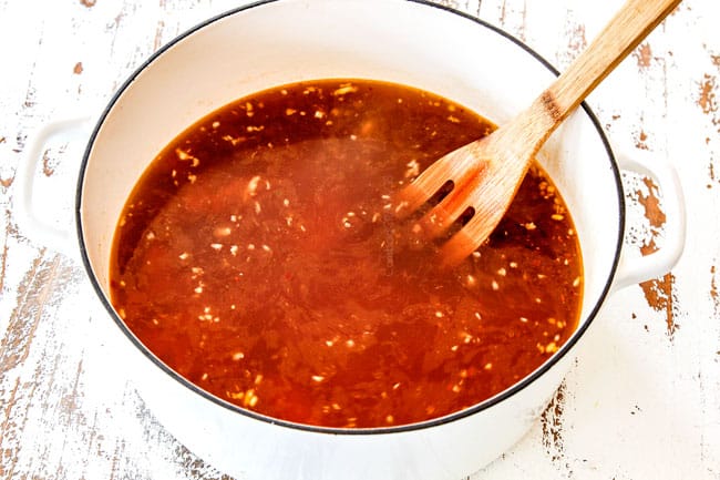 wonton soup broth in large white soup pott