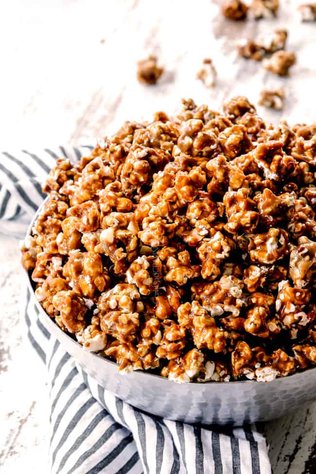 a far away side view of best caramel popcorn in a silver bowl