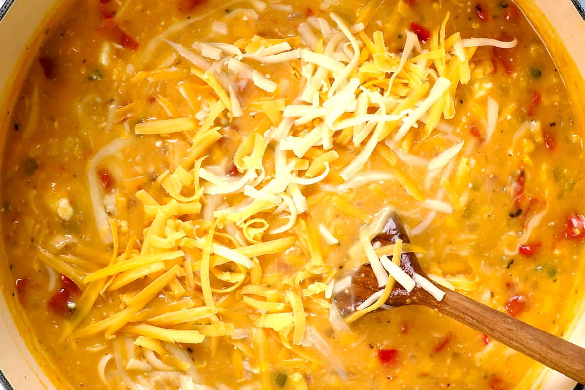 showing how to make chicken corn chowder by stirring in cream cheese until melted, followed by shredded cheddar and Monterrey Jack cheese until melted.