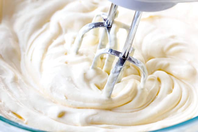 showing how to make Chocolate Eclair Cake by whipping vanilla pudding and homemade whipped cream together