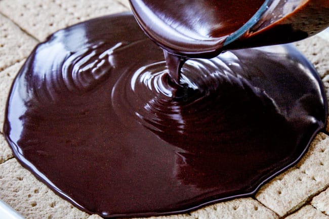 showing how to make easy Chocolate Eclair Cake by pouring chocolate ganache over graham crackers
