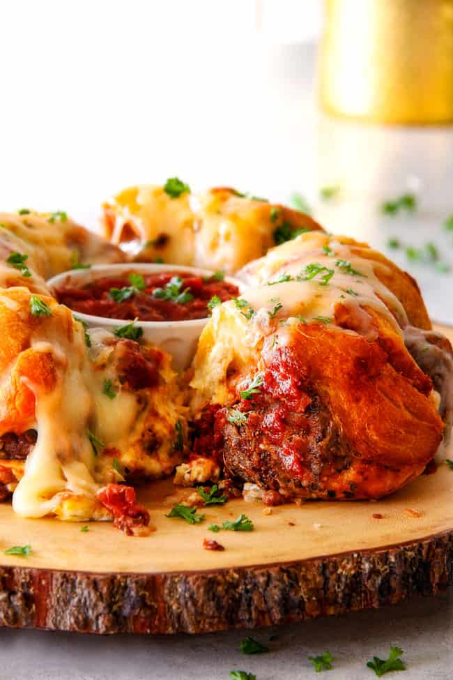 far away view of pull apart bread made in a bundt pan with meatballs and cheese