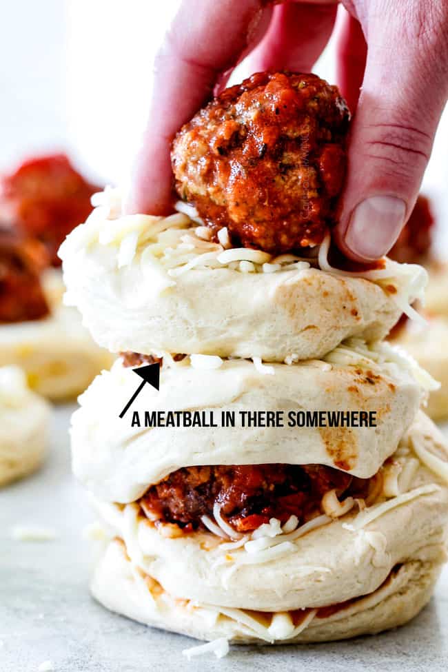 showing how to make pull apart bread by stacking biscuits together with cheese and meatballs