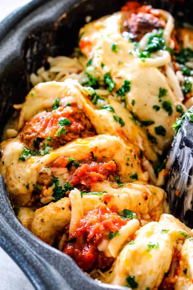showing how to make pull apart bread by adding laying biscuits in a bundt pan
