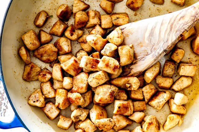 showing how to make best chicken divan recipe by cooking chopped chicken in a pan