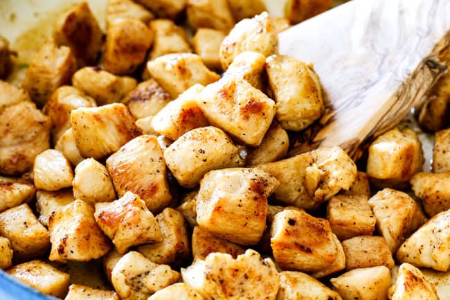 up close of cooking chopped chicken in pan showing how to make chicken divan without cream soup