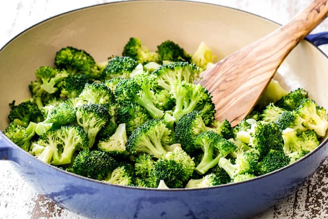 showing how to make chicken divan by steaming broccoli in a blue skillet
