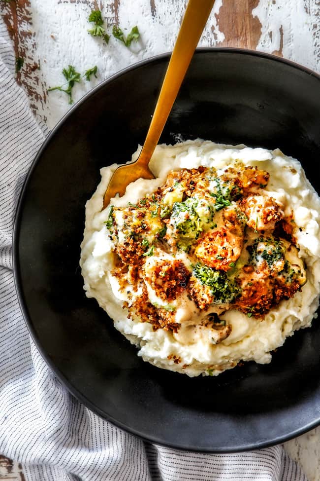top view of a serving of best chicken divan with mashed potatoes in a black bowl