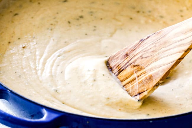 showing how to make from scratch chicken divan by making mornay sauce in a blue pan