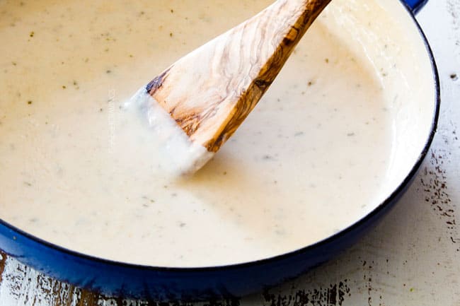 showing how to make easy chicken divan by adding chicken broth and milk to a pan to make mornay sauce