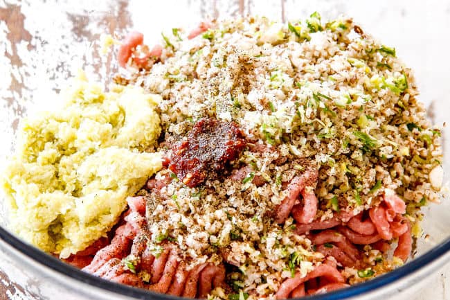 showing how to make the best potstickers by adding ground pork, Napa cabbage, green onions, garlic, ginger, shiitake mushrooms, soy sauce, sesame oil to a glass bowl for the filling