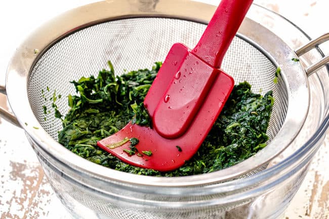 showing how to make hot spinach artichoke dip recipe by pressing liquid out of frozen spinach