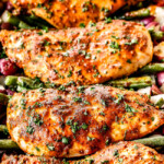 up close front view of front view of honey mustard chicken and potatoes in a blue baking dish