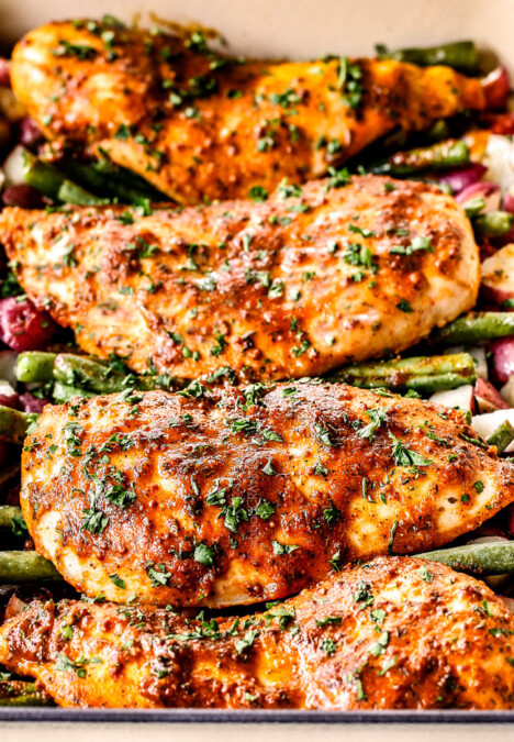 up close front view of front view of honey mustard chicken and potatoes in a blue baking dish