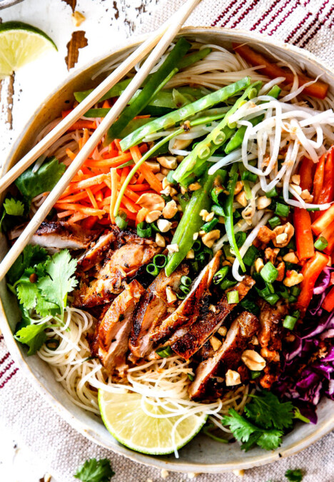 top up close view of Vietnamese noodle with rice noodles, lemongrass chicken, shredded carrots, julienned carrots, bean sprouts and snow peas
