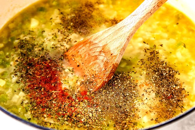 showing how to make cauliflower soup by stirring parsley, oregano, cayenne pepper into soup